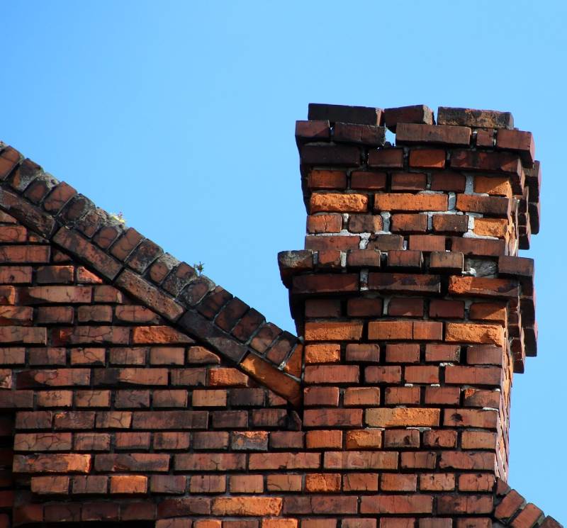 Damaged chimney on an Rosedale home showing cracks and missing mortar